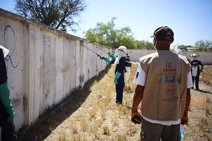 Spray operators spraying a wall with a supervisor watching them. Photo credit: Arnaud Rakotonirina, VectorLink Madagascar Monitoring and Evaluation Manager